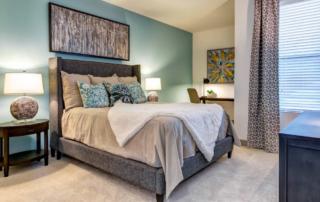 Studio, One and Two Bedroom Apartments in Tempe, AZ - Vela at Tempe Town Lake Apartments Bedroom With Cozy Carpeting, Large Window and Chic Decor