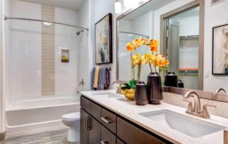 Tempe, AZ Apartments - Vela at Tempe Town Lake Bathroom with Updated Light Fixtures and Modern Decor
